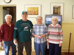 Photo of seniors playing a Wii console game together. Image of a aging-friendly community