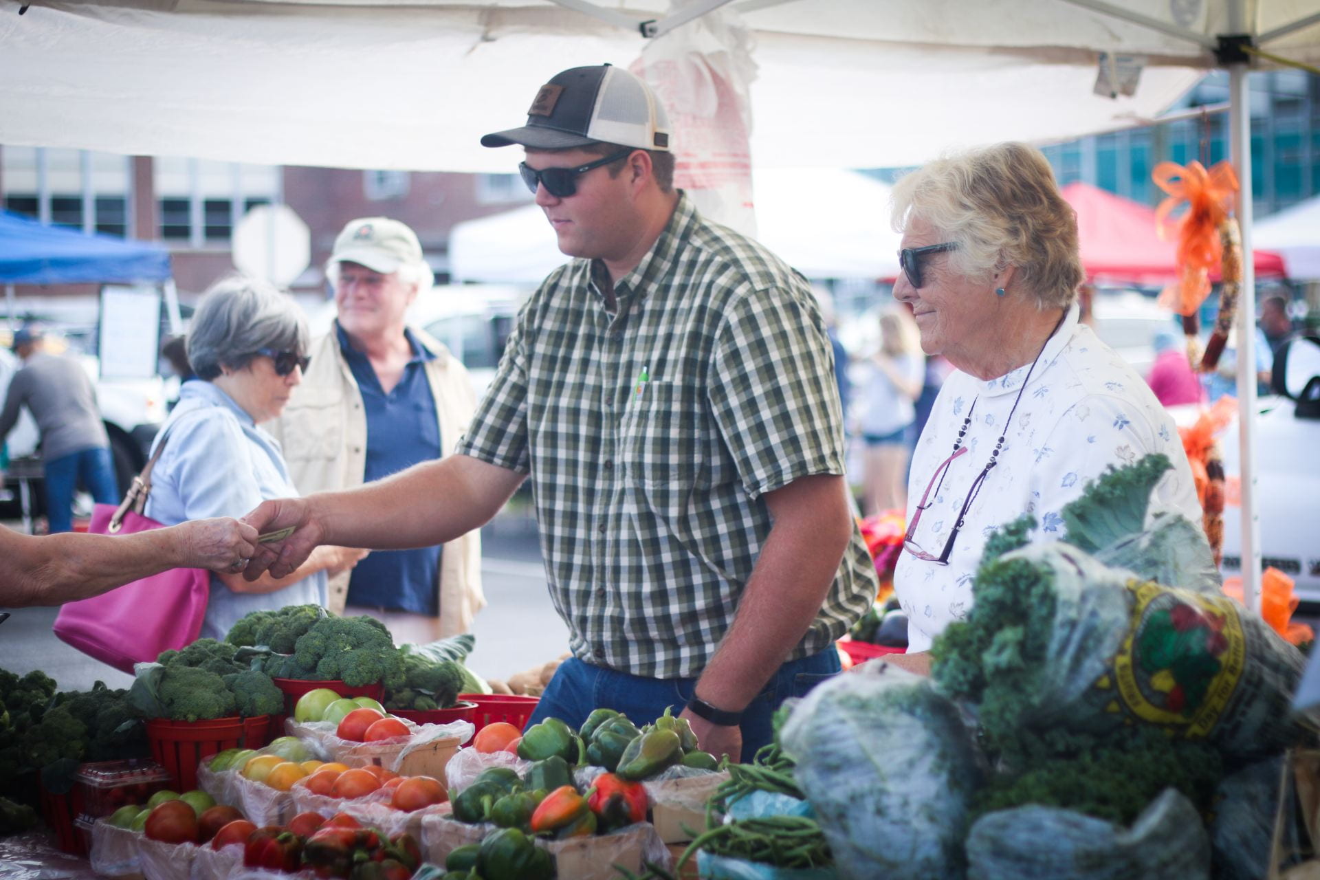 Image showing a man purchases fresh vegetables at the Historical Lewes Farmers’ Market.