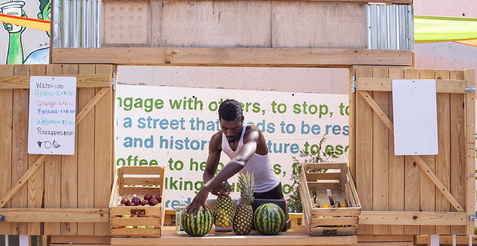 Image of a Wilmington Green Box employee preparing to sell fresh fruits and vegetables.